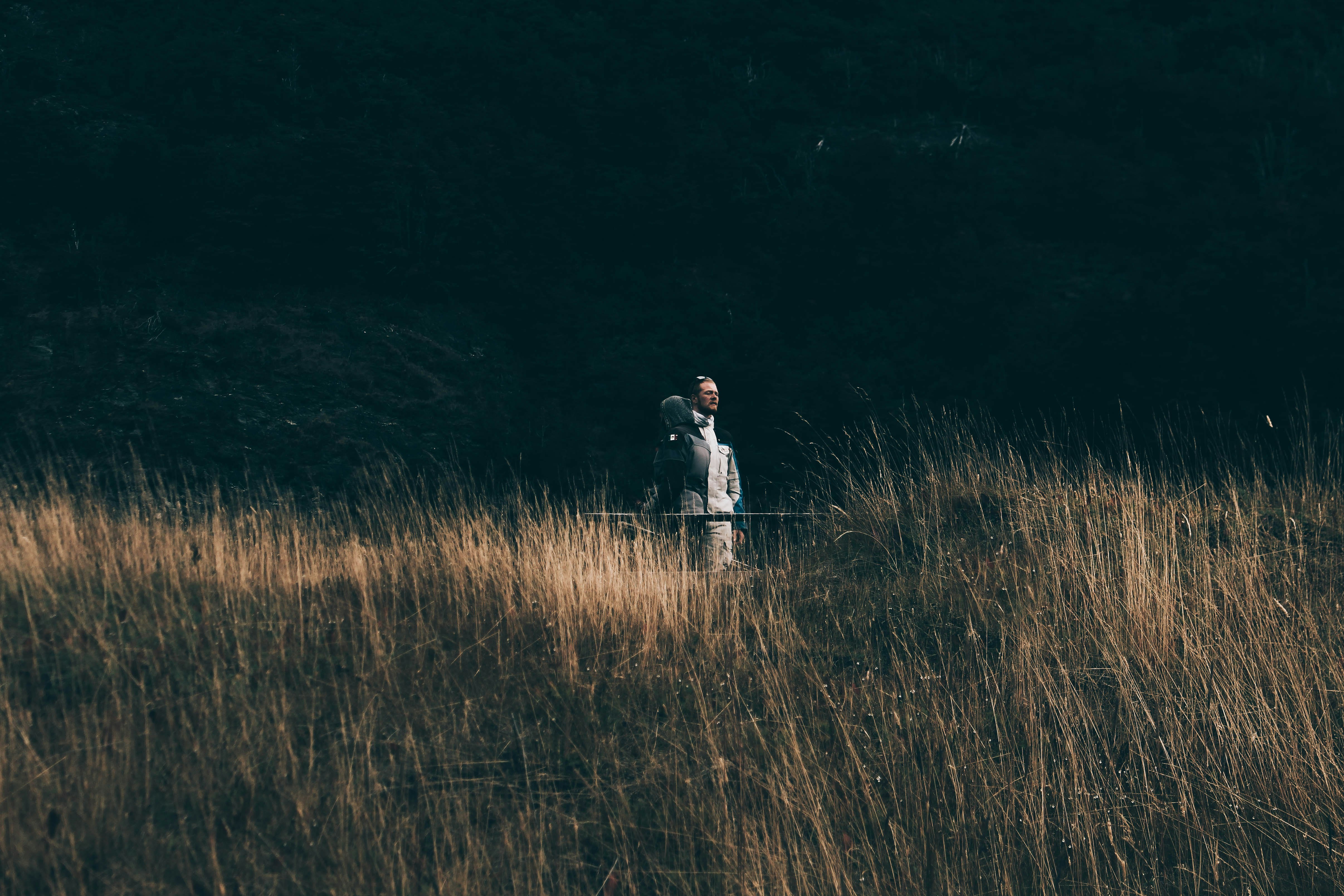 person on brown grass at daytime