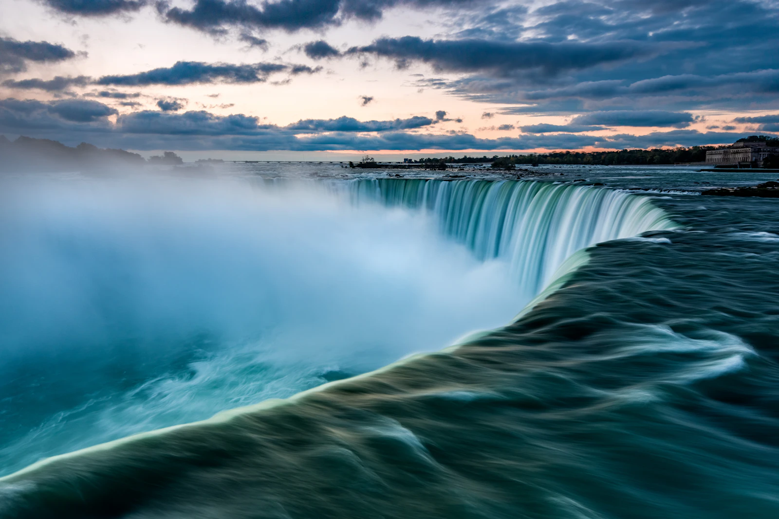Large waterfall and mist viewed from a scenic overlook