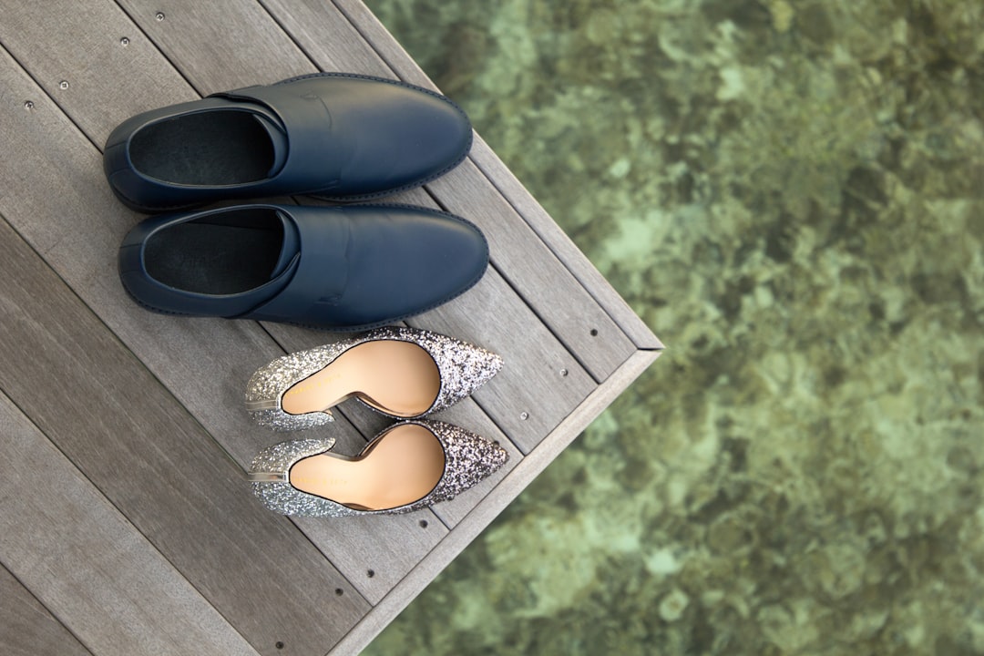pair of gray leather dress shoes and silver-glittered pumps, honeymoon in finolhu