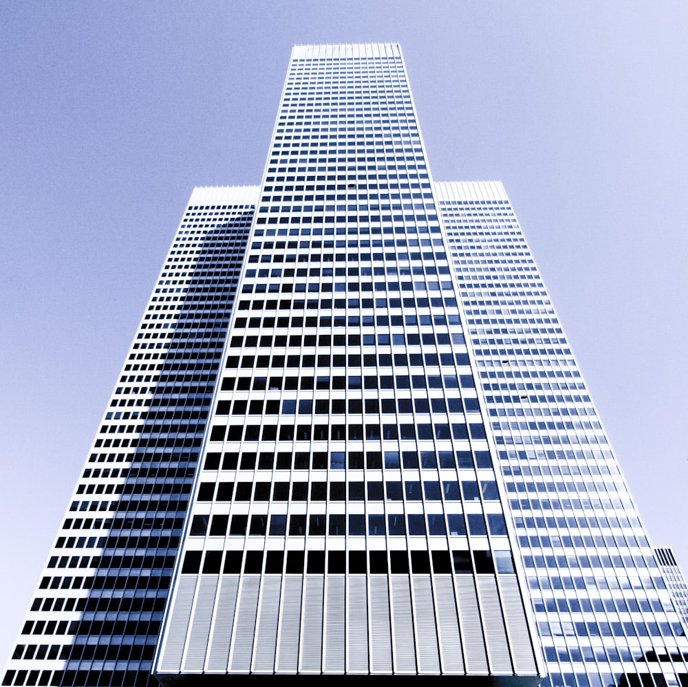 A tall white skyscraper on a bright day in Montreal