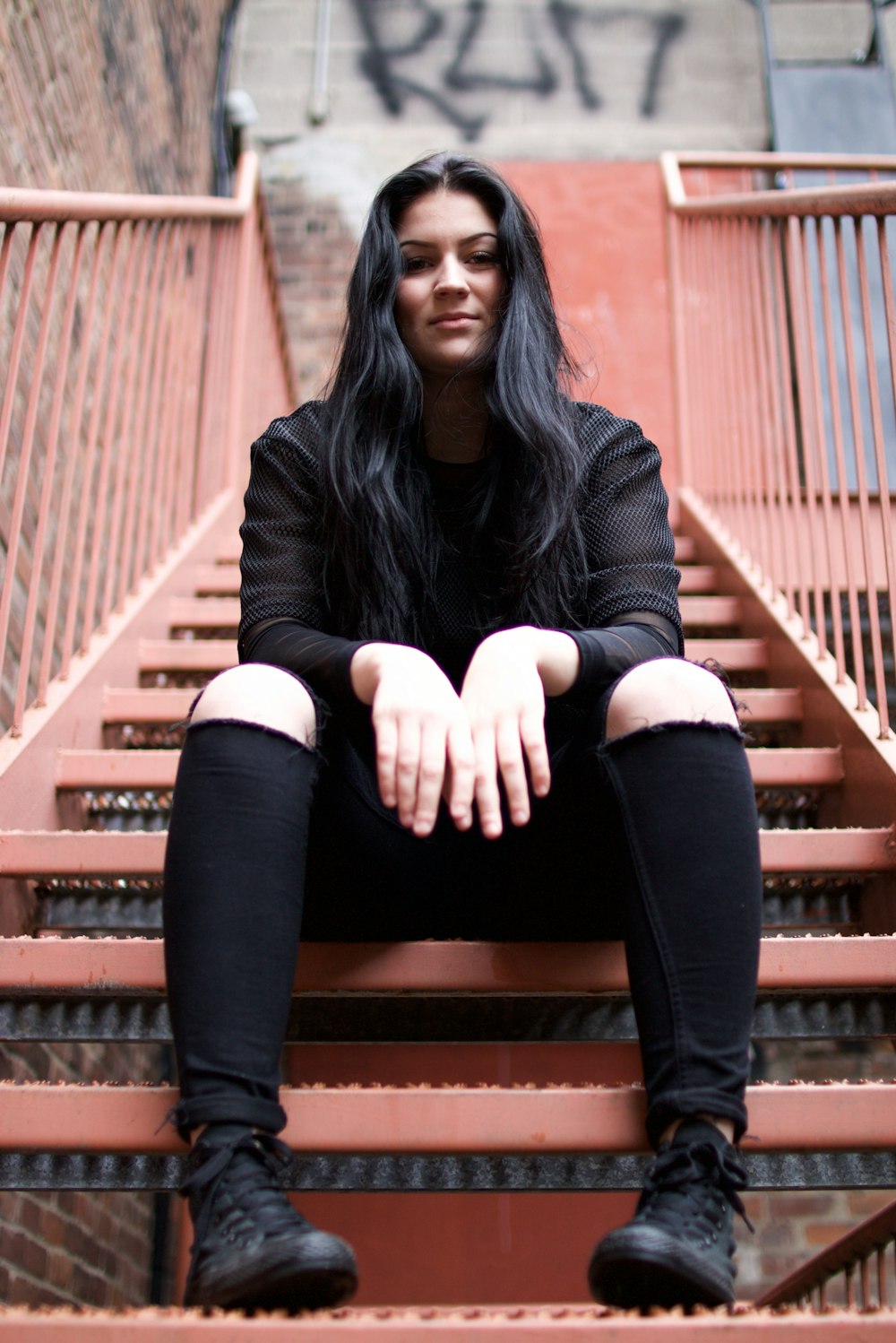 woman sits on stairwell