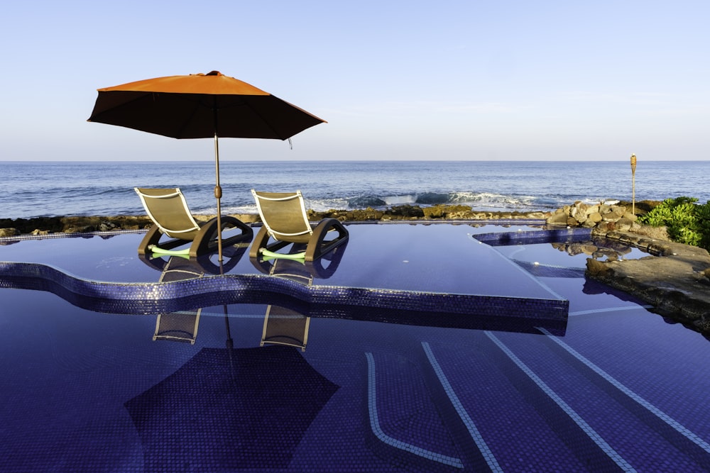 brown umbrella on swimming pool during daytime