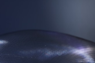 Macro tech detail showing fine textures and subtle lighting gradients in dark colors.