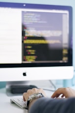 person in front of iMac