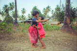 Children playing near the lush green paddy fields, embodying the spirit of childhood in Kerala.