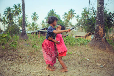 Children playing near the lush green paddy fields, embodying the spirit of childhood in Kerala.