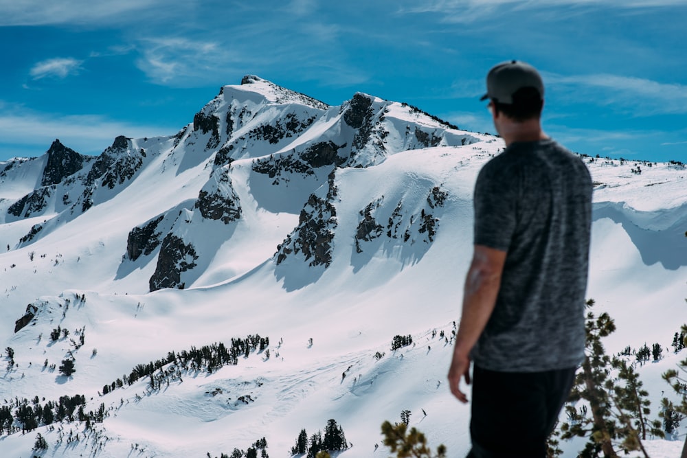 man looking at snow mountain