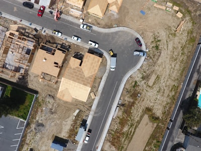 An aerial view of a developing neighborhood with houses and open plots.