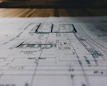 High-resolution architectural blueprint print spread out on a table