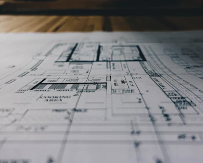 Blueprints and construction plans spread out on a desk.