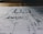 A detailed architectural blueprint spread out on a flat surface, with lines and annotations indicating various sections and measurements. The image is focused, balancing clarity with a slightly blurred background indicating depth.