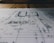 A detailed architectural blueprint spread out on a flat surface, with lines and annotations indicating various sections and measurements. The image is focused, balancing clarity with a slightly blurred background indicating depth.