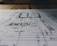 A detailed architectural blueprint spread out on a flat surface, with lines and annotations indicating various sections and measurements. The image is focused, balancing clarity with a slightly blurred background indicating depth.