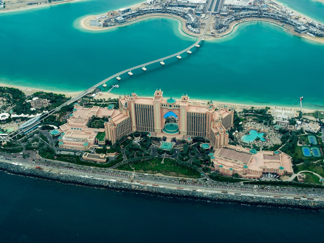 aerial photography of concrete buildings on the middle of the sea, Taken on a plane…