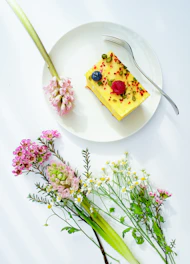 round white plate beside flowers