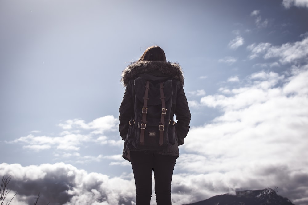 woman looking at clouds under blue sky during daytime