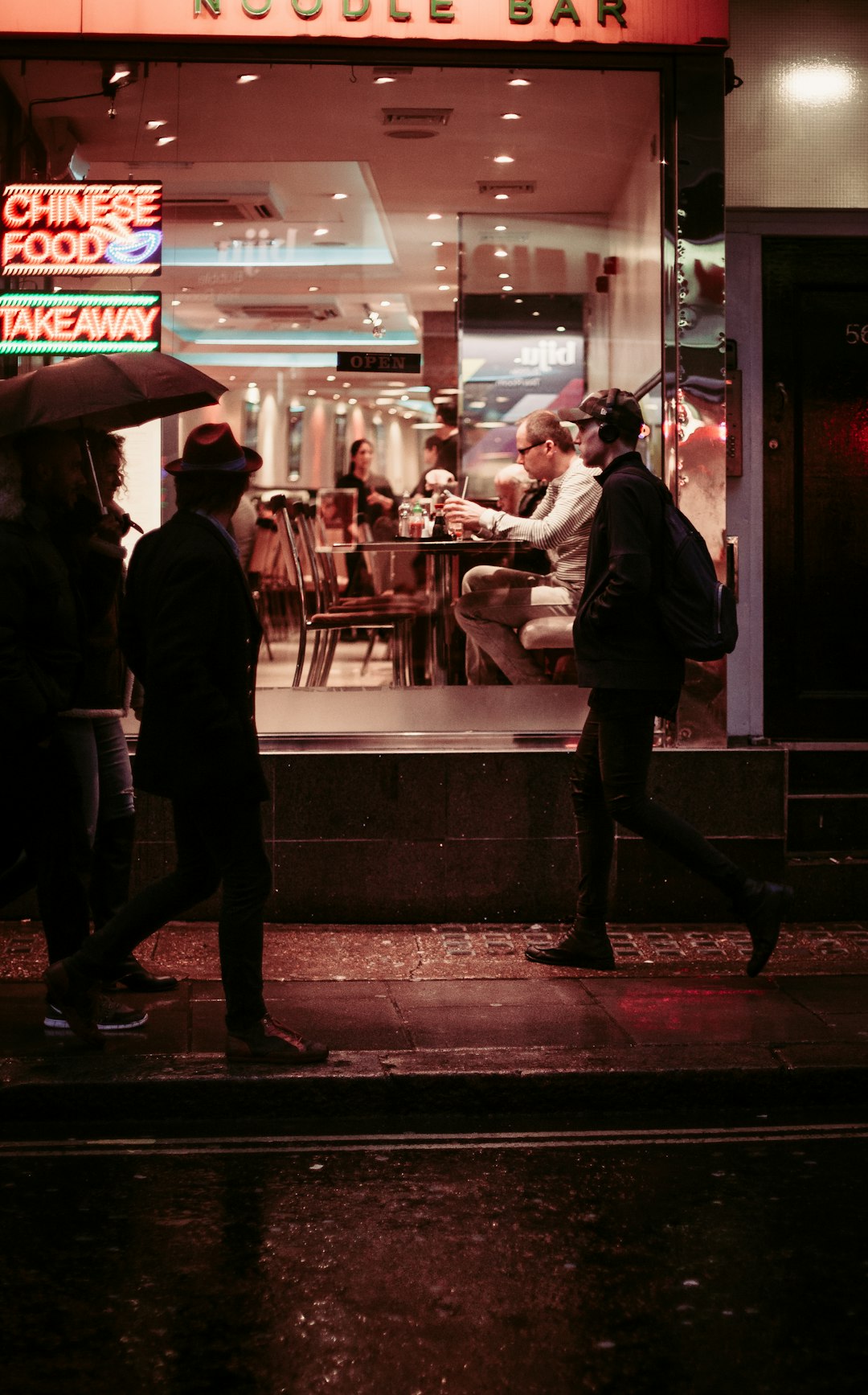 man walking near restaurant wearing jacket