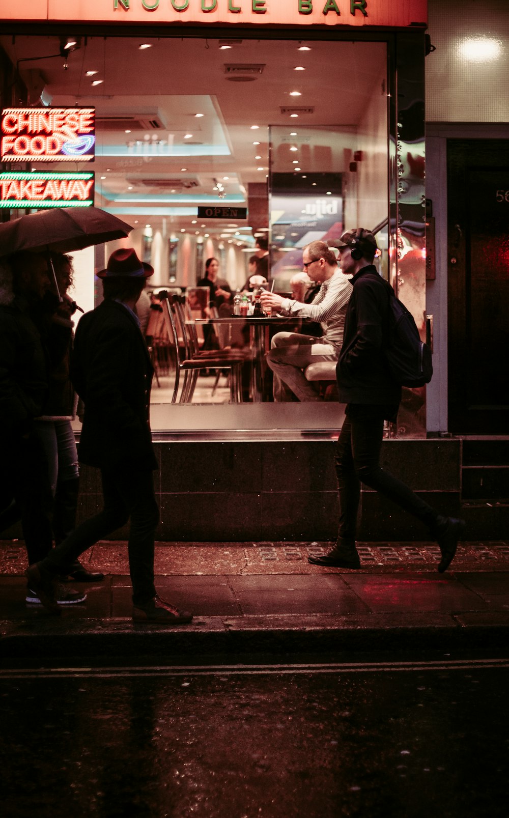 Mann geht in der Nähe eines Restaurants spazieren und trägt Jacke