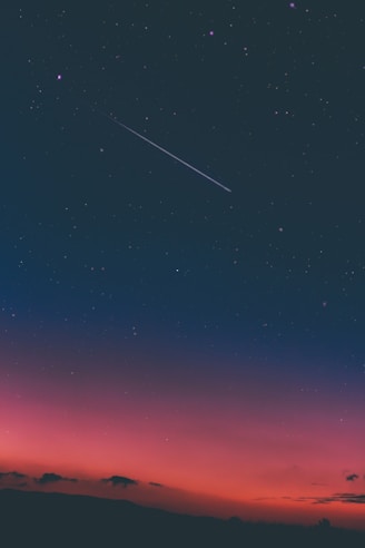 a shooting star in night sky