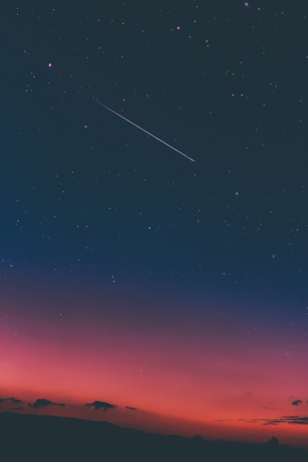 a shooting star in night sky