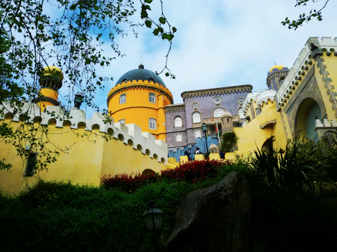 Minecraft castle built with colorful blocks under a bright blue sky.