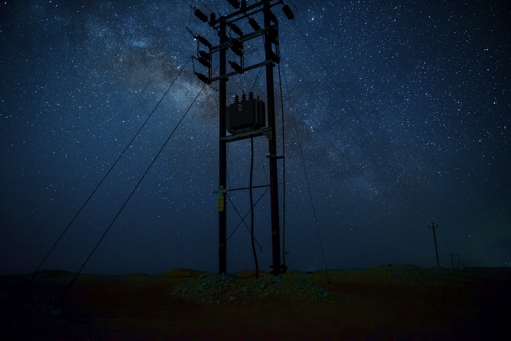 silhouette photography of post during starry night