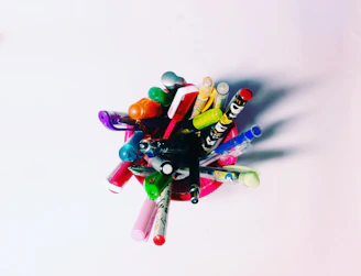 Close-up of vibrant pens and markers in a clear holder, ready for creative use.