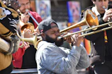 Close-up of musicians passionately playing congas and trumpet during a salsa concert