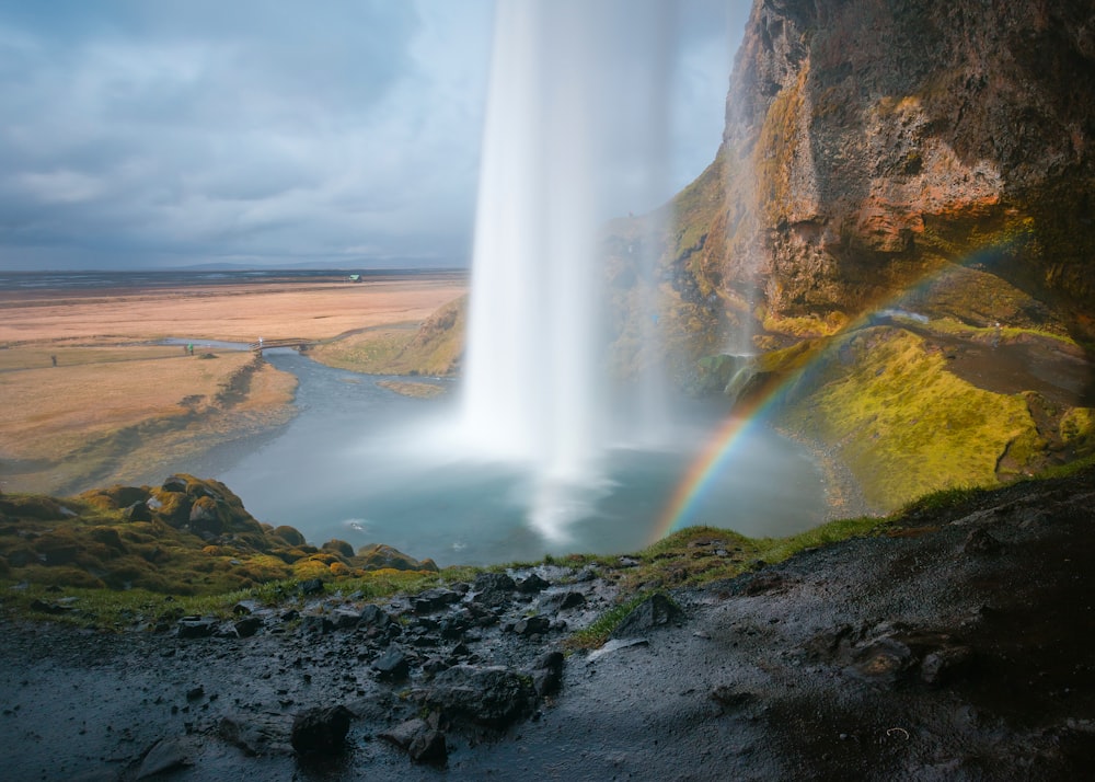 waterfall under grey sky