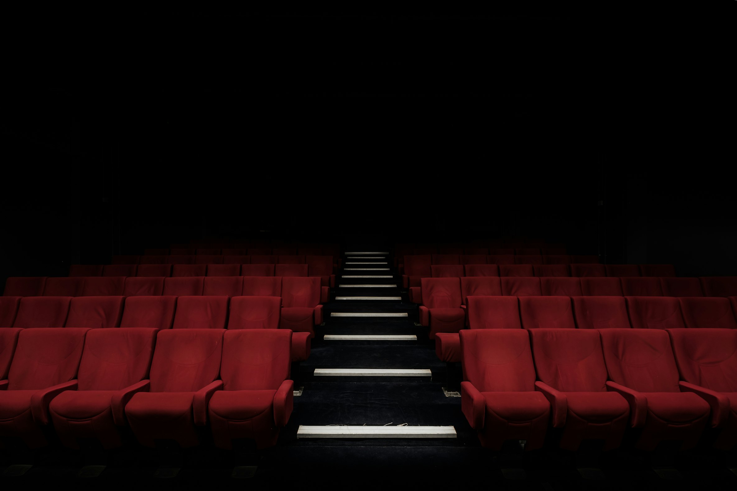 Empty theater with red seats, photographed by Felix Mooneeram