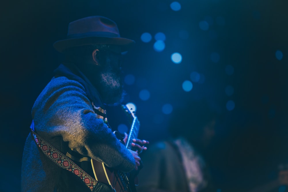 bokeh shot of man playing guitar