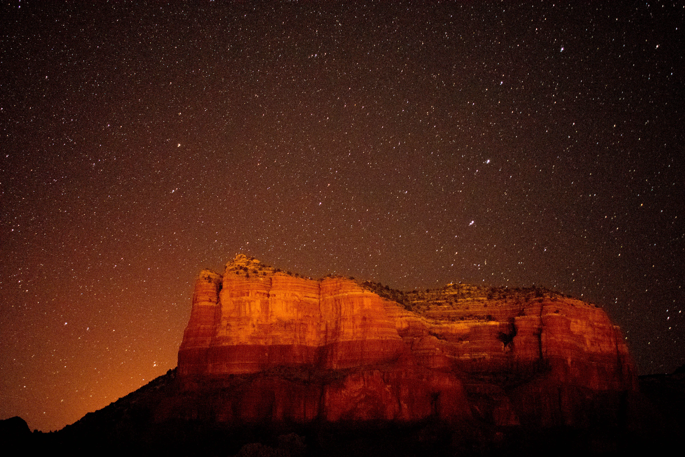 Red sandstone bluff under a Southern Utah night sky