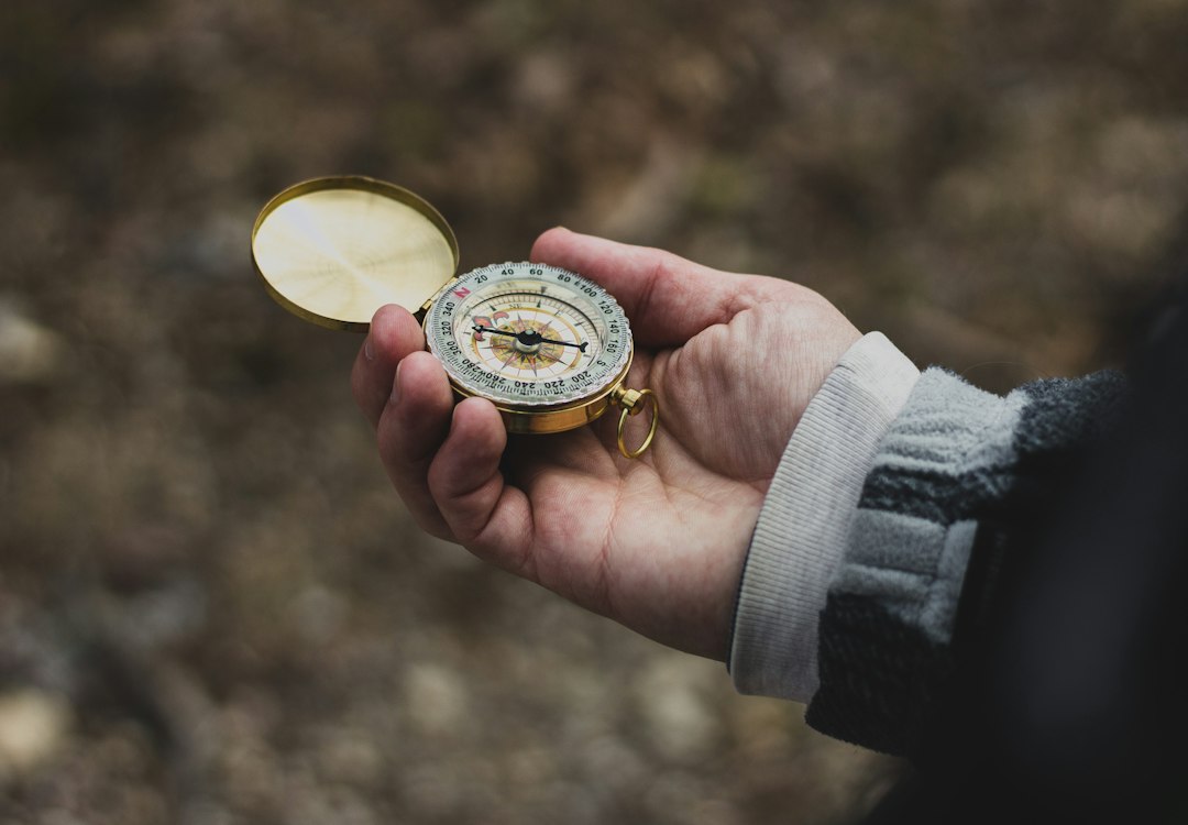 person using white and gold compass, Sense of direction