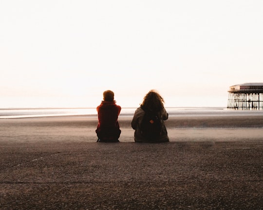 two people sitting and looking at the sea in Blackpool United Kingdom