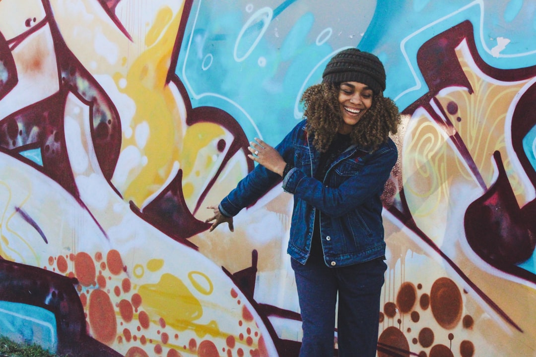 Woman smiling in front of graffiti