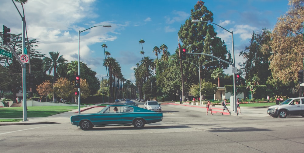 teal car on gray concrete road