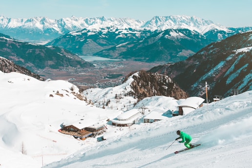 A young girl skiing down a snowy slope in the French Alps.