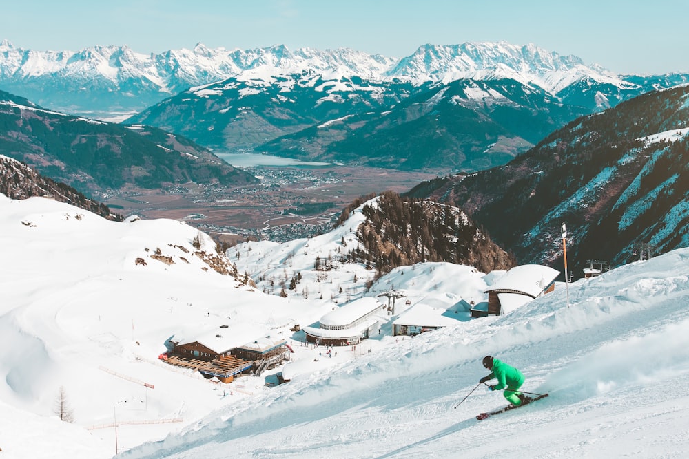 산에 둘러싸인 겨울에 스키를 타는 사람