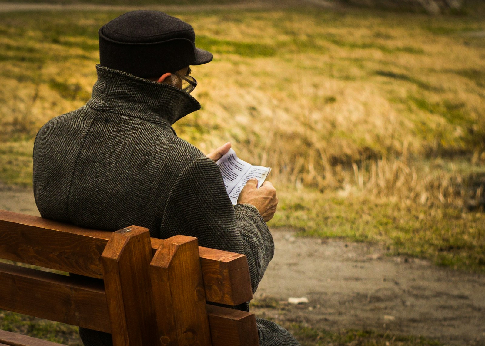 Canon EF 35-80mm f/4-5.6 sample photo. Man holding paper sitting photography