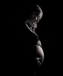 pregnant woman holding tummy