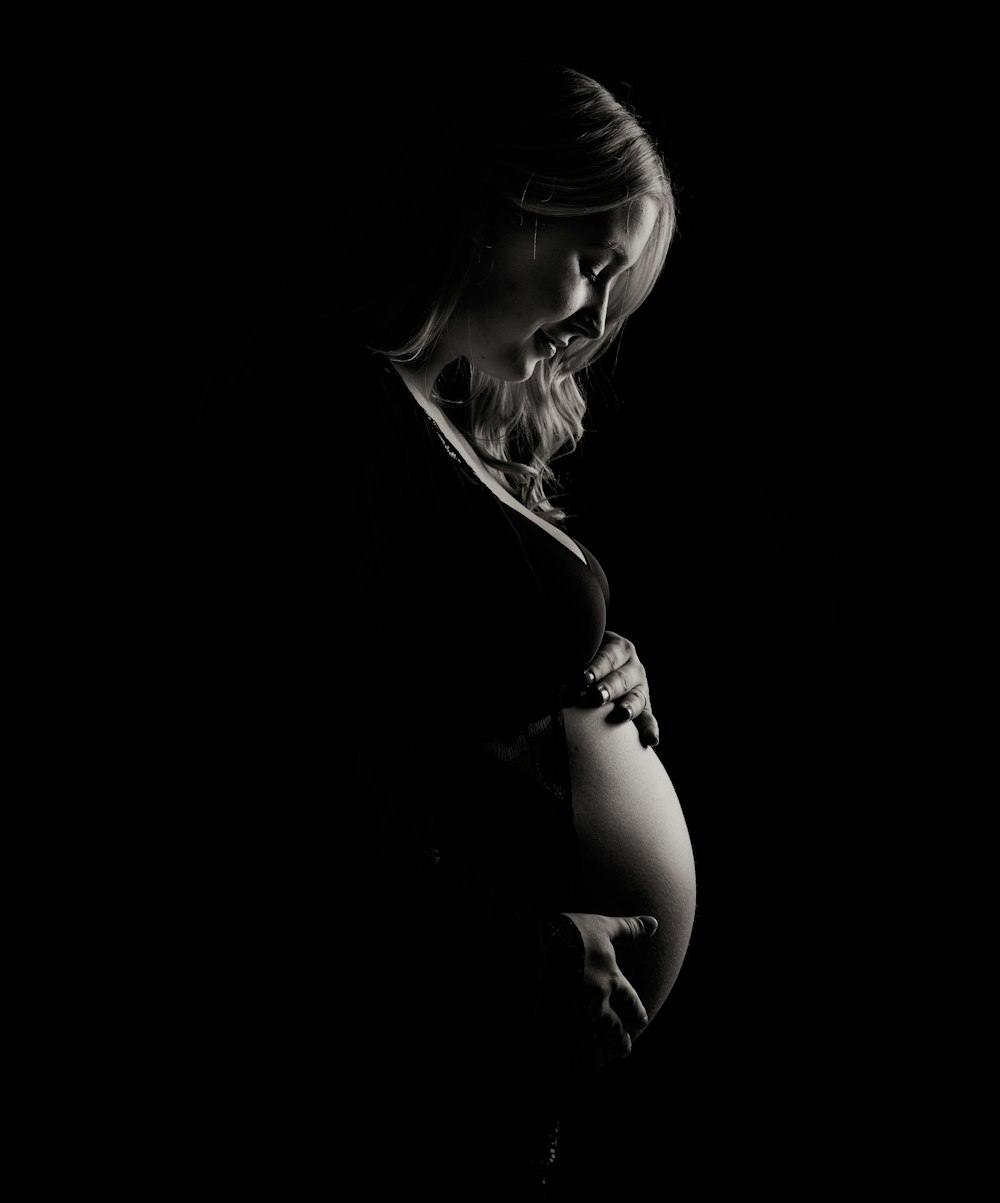 pregnant woman holding tummy
