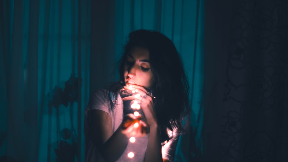 woman holding LED string light