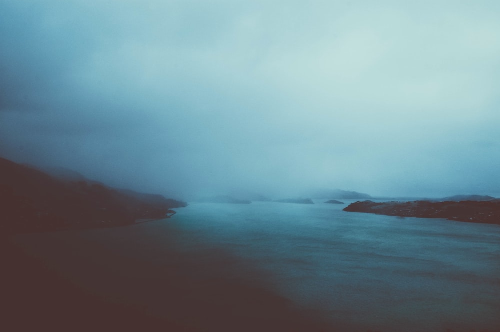 cloudy sky over calm body of water