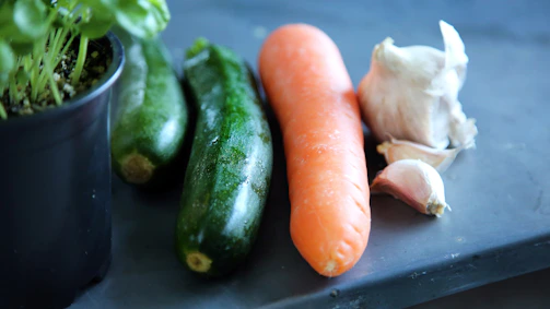 A close-up of fresh vegetables freshly picked from a garden bed.