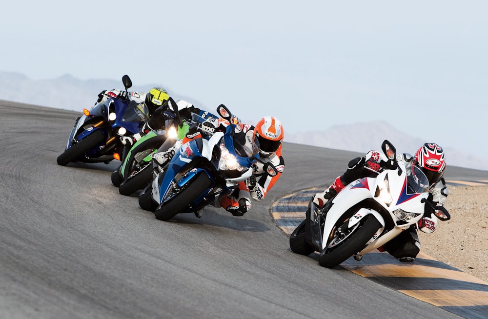 group of people riding sports motorcycles