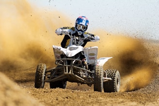 man riding ATV on the dessert