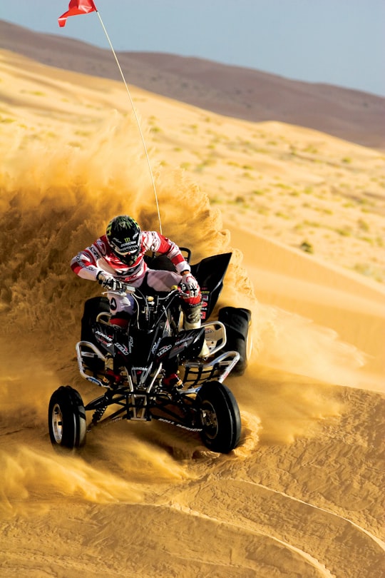 person riding on ATV and drift on sand in Glamis United States