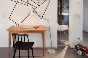 Minimalist workspace featuring engineering models, laptops, and sleek design elements