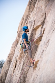 man doing rock climbing at daytime