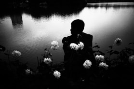 A peaceful nature scene with a person meditating by a quiet lake
